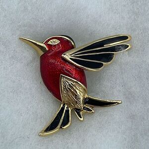 Vintage red enamel hummingbird with rhinestone eye brooch.